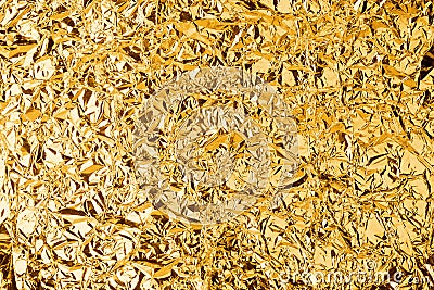 Crumpled golden foil shining texture background, bright shiny gold luxury design, metallic glitter surface Stock Photo