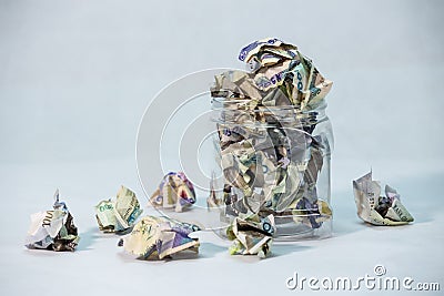 Crumpled naira notes in a bottle with white background Stock Photo