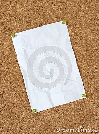 Crumpled paper pinned to corkboard Stock Photo