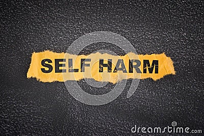 Crumpled piece of paper with words Self Harm Stock Photo