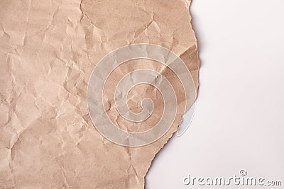 Crumpled recycled paper with a torn edge on a white background Stock Photo
