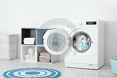 Crumpled towels in washing machine at home. Laundry room Stock Photo