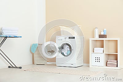 Crumpled towels in washing machine at home. Laundry room Stock Photo