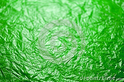 Crumpled ufo green polyethilene film abstract background with selective focus Stock Photo