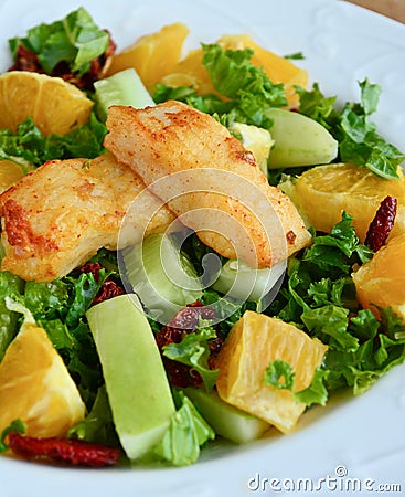 Crunchy green salad with pecans ,sweet lime and fish Stock Photo
