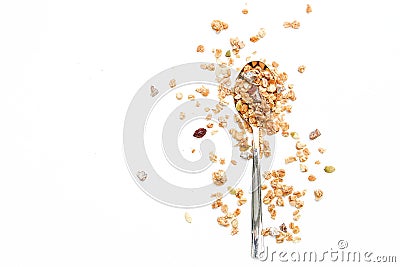 Crunchy muesli on a spoon Breakfast cereals isolated on a white background, selective focus, top view Stock Photo