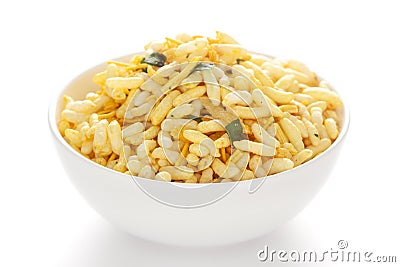 Crunchy Murmura in a white ceramic bowl made with Puffed Rice and Curry leaves. Stock Photo