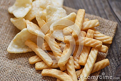 Crunchy prawn crackers or shrimp crisp rice and ketchup for traditional snack - prawn crackers stick on sack and wooden table Stock Photo