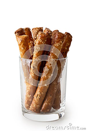 Crunchy salty pretzel rods in glass isolated on white. Stock Photo