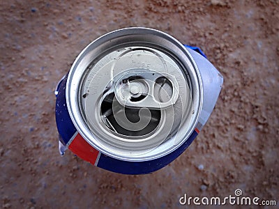 Crushed Can on Ground Dirt as Trash Litter Stock Photo