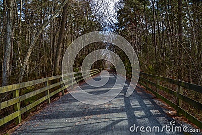 Biker Crosses Crushed Stone Path Bridge at Henlopen State Park`s Junction Stock Photo