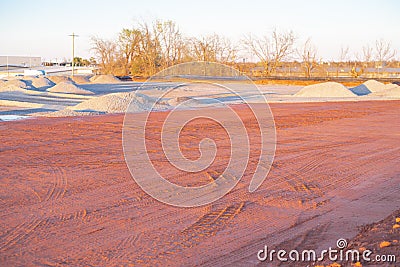 Crushed gravel piles up heap at construction site near warehouse district North of Oklahoma City, truck tire tread machinery Stock Photo