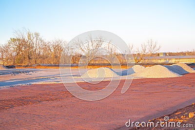 Crushed gravel piles up heap at construction site near warehouse district North of Oklahoma City, truck tire tread machinery Stock Photo