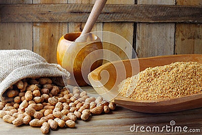 Crushed and ground peanuts in the wooden bowl forming a flour ingredient for the peanut butter and paste and Brazilian paÃ§oca Stock Photo