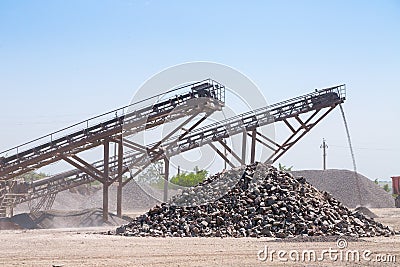 Crushing machinery, cone type rock crusher, conveying crushed gr Stock Photo