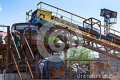 Crushing machinery, cone type rock crusher, conveying crushed gr Stock Photo