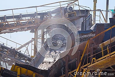 Crushing machinery, cone type rock crusher, conveying crushed gr Stock Photo