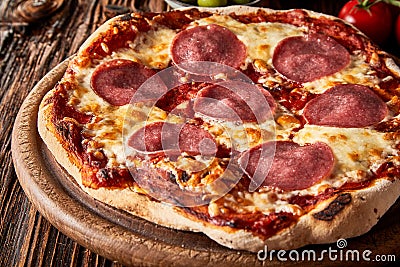 Crusty Italian pepperoni or salami pizza Stock Photo