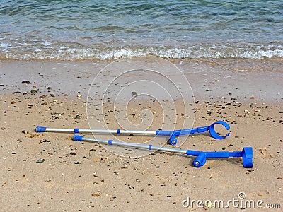 Crutches on beach Stock Photo