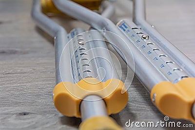 Crutches on the floor close-up. Concept: disability, trauma, medical care Stock Photo