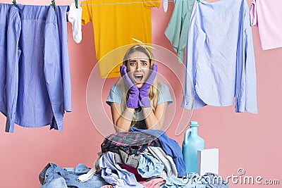 Cry of despair from housewife. Girl with heap of dirty clothes Stock Photo