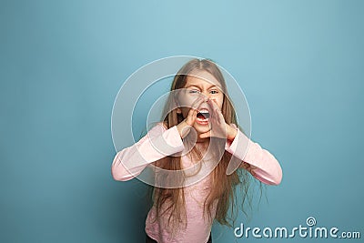 The cry. Teen girl on a blue background. Facial expressions and people emotions concept Stock Photo