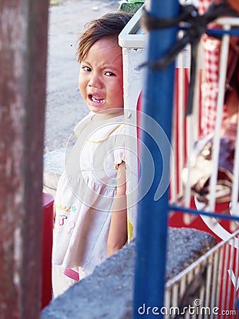 Crying Baby Hiding Behind the Cooling Box Editorial Stock Photo