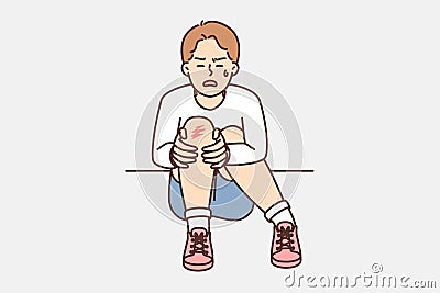 Crying boy sits on ground and holds on to injury on knee after fall during walk Vector Illustration