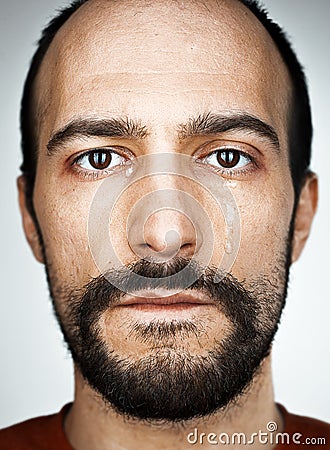 The crying man with tears on face closeup Stock Photo