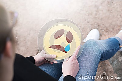 Crying paper emoticon in hand Stock Photo