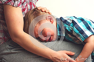 Crying unhappy boy hugging his mother Stock Photo