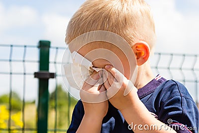 Crying unhappy little boy wiping his eyes Stock Photo