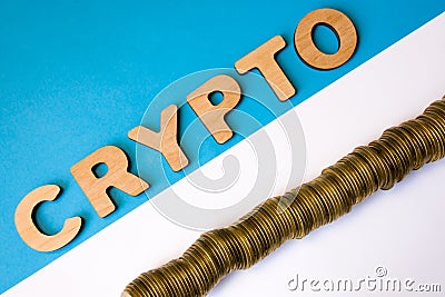 Crypto and cryptocurrency coin photo concept top view. Word crypto composed of volumetric 3D letters is opposite pile of coins lyi Stock Photo