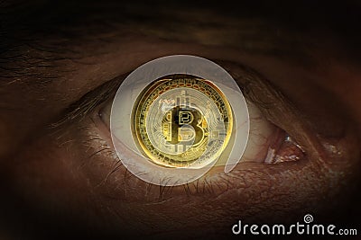 Crypto currency Gold bitcoin. Macro shooting bitcoins. Eye of a man with a bitcoin coin reflected in a student. Stock Photo