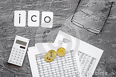 Initial coin offering ICO with coins, calculation table, office tools on gray textured background top view Stock Photo