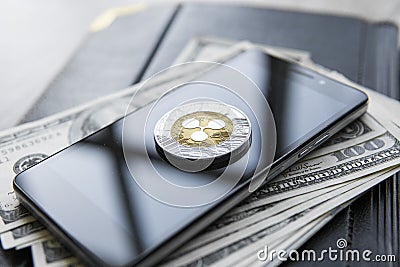 Crypto currency ripple xrp on smartphone and us dollars money background. Blockchain and cyber currency. Global money Editorial Stock Photo