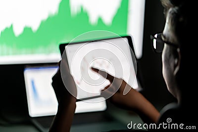Crypto trader investor analyst looking at computer screen analyzing financial graph data on pc Stock Photo