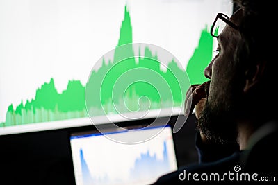Crypto trader investor analyst looking at computer screen analyzing financial graph data on pc Stock Photo