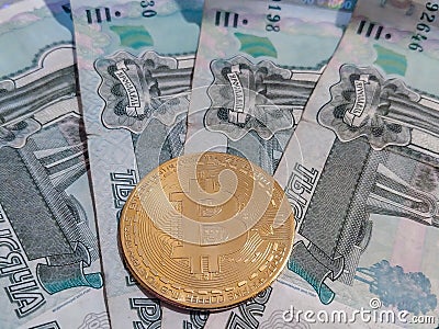 Cryptocurrency coin bitcoin on the background of Russian four thousand rubles May 27, 2022 St. Petersburg Russia Editorial Stock Photo