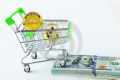 Cryptocurrency Dogecoin in close-up on a white background, growth concept, coins in a shopping cart on a bundle of dollars Editorial Stock Photo