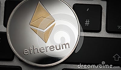 Cryptocurrency Ethereum coin on computer laptop keyboard. Editorial Stock Photo