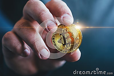 Cryptocurrency golden bitcoin coin in man hand - symbol of crypto currency - electronic virtual money Stock Photo