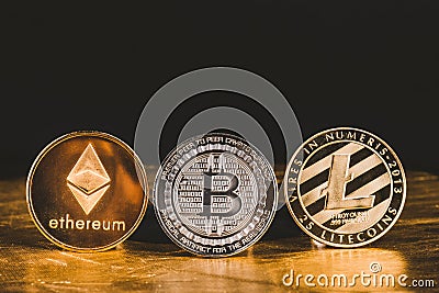 Cryptocurrency litecoin,Silver Bitcoin,Ethereum on golden floor Editorial Stock Photo