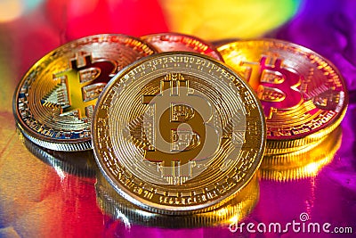 Cryptocurrency physical golden bitcoin coin on colorful background Stock Photo