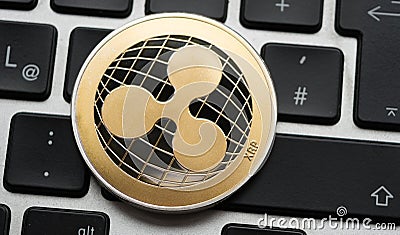 Cryptocurrency Ripple coin on computer laptop keyboard. Editorial Stock Photo