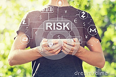 Cryptocurrency risk theme with young man holding his smartphone Stock Photo