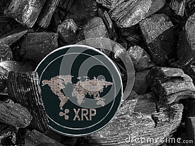 Cryptocurrency XRP coin lies on coal. Mining and Energy for mining. Editorial Stock Photo
