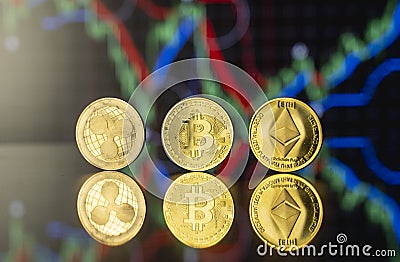 Cryptocyrrency and virtual money concept. Golded bitcoin, ethereum and ripple coins with chart of growing and falling Editorial Stock Photo