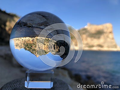Crystal ball and coastal landscape, creative refraction photography Stock Photo