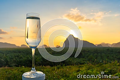 A crystal ball place on the top of a glass of water. Stock Photo